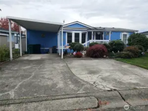 Great Picture of the Front of the Home Showing Carport and Parking Enough for 3 Vehicles.