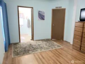 A Different View of the Spacious Primary Master Bedroom with Cathedral Ceilings, Full Wall Closet and Laminate Flooring showing the Primary Bathroom.