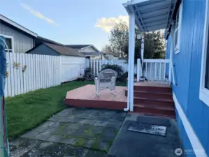 A View of the Nice Size Pet Friendly Fully Fenced Backyard Showing Covered Deck and Larger Deck Below.