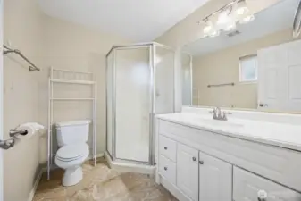Attached 3/4 bathroom with white vanity and walk-in shower.