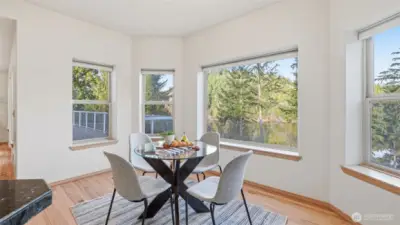 Enjoy morning coffee with serene water views from this bright breakfast nook.