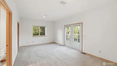 A versatile secondary primary bedroom offering space, privacy, and main-level convenience.