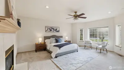 A peaceful primary retreat featuring large windows and space to relax and unwind.