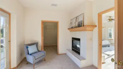 “Private sitting area just off the primary suite, complete with a cozy fireplace and direct access to the walk-in closet & primary ensuite