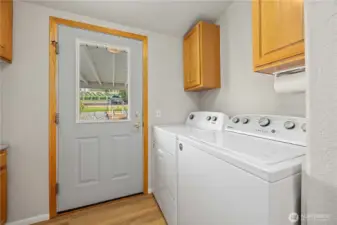Laundry with door out to covered patio & garage