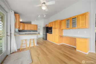 Kitchen with additional dining area and door to covered porch.