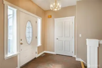 Entry with coat closet, staircase leading to lower level