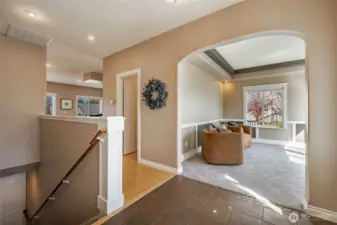 Entry looking at office/den and staircase, guest bath is in the hall