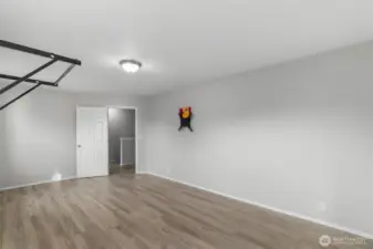 Another angle of the bonus room with newer LVP flooring for ease of care and durability. What will you use it for?