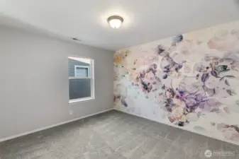 Bedroom number two with a beautifully embellished wall