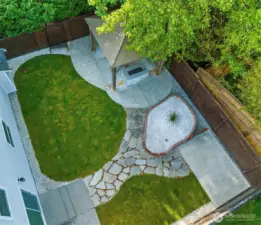 This yard is "just right sized". It is nicely landscaped with a flagstone path connecting the entertaining spaces.