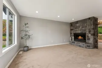 upstairs living room with a cozy wood fireplace.