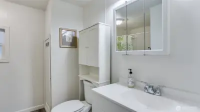 The primary offers a 3/4 bath en suite with white vanity, ample storage space and a walk-in shower.