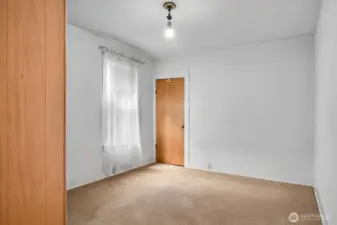 The main bedroom on the main floor with a window facing west.