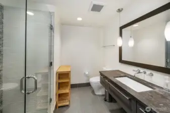 Spacious spa inspired bath with glass mosaic.