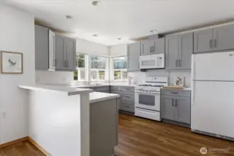 Sleek and airy - a modern kitchen with light grey cabinets that blend style, warmth, and functionality.