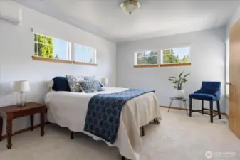 Primary bedroom with plenty of windows filling the room with natural light.