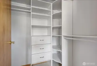 Updated primary closet with drawers and shelves to keep things neatly organized and easy to find.