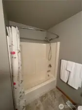Tub/shower combination in guest bath.