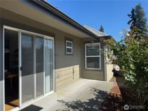 Back patio bathed in abundant sunlight perfect for relaxing or entertaining outdoors