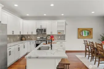 Spacious and elegantly modern kitchen with an open dining area.
