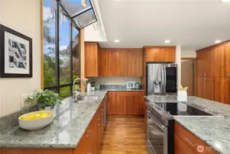 Remodeled kitchen featuring slab granite, stainless appliances, and soft close cabinets