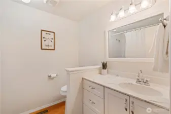 Main bath with large jetted tub/shower with grab bars for safety.