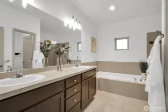 Bright bathroom with generous vanity and storage.