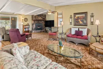 Open and spacious living room that looks into the family room with fireplace that has a wood insert!