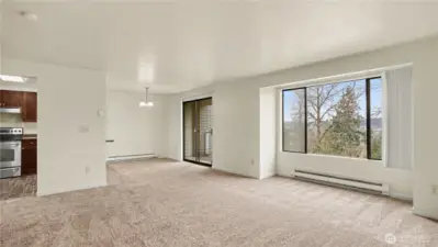 The living room offers the perfect ambiance with the natural light and the cozy fireplace.