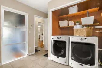 Dedicated laundry room with additonal built-in storage.