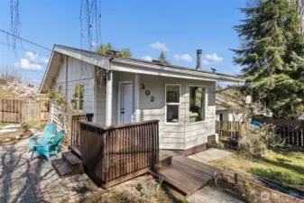 A 1915 South Park bungalow on a quiet corner. Covered entry porch, cobblestone path, and a wood stove flue that means business.