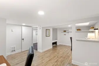 The bonus room opens to the daylight corridor beyond — wall heater on board for the zones the mini-split doesn't reach.