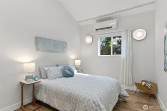 The second bedroom — vaulted ceiling, mini-split, wall sconces, south-facing window. Not what you'd expect at this level.