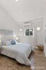 The skylight seals it — vaulted ceiling, natural light from above and through the south-facing window. This bedroom lives above its grade.