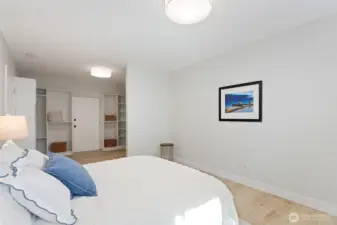 The bed, the light, and behind it — a walk-in closet that means business.