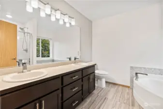 Beautiful primary 5 piece bathroom with a large soaking tub.