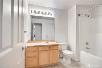 Full bathroom with two doors for entry.