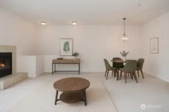 Living room with fireplace opens up to dining area. Virtually Staged.
