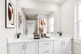 Primary bathroom featuring a dual vanity and generous counter space. Photo is staged and represents the same floor plan in another home.