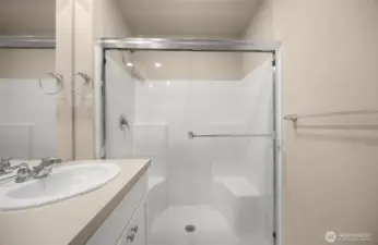 Primary bathroom with double vanity and walk in shower