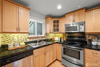 Beautifully updated kitchen with granite counters and stainless appliances - all stay!
