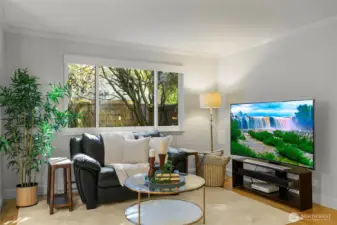 Living room looks out onto private fenced yard!