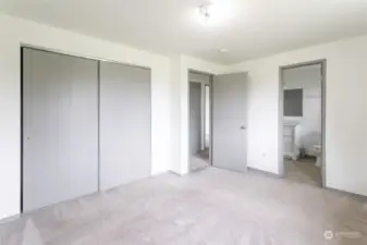 View of master bedroom with walk in full bathroom and huge closet