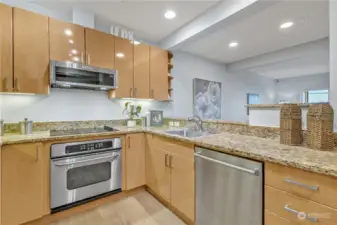 Beautiful gleaming cabinetry, slab granite, and under-cabinet lighting. Stainless steel appliances all stay.