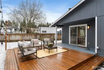 New, Large Wood Deck with wrap around stair has comvenient access to the mostly fenced dog run.