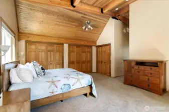 Loads of storage space with a wall of closets and walk in closet combined.