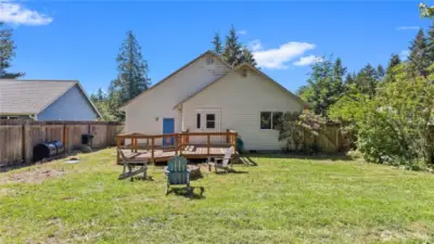 From the fruit trees looking toward the deck with ramp, convenient door from deck to the second BR.