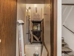 Closet with water tank and additional storage space opposite front