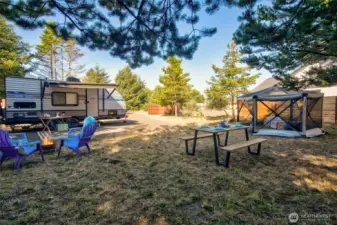 A secluded lot with trees on three sides and a privacy fence on the fourth. Features full hookups and a gravel drive—ideal for long stays or weekend getaways.
